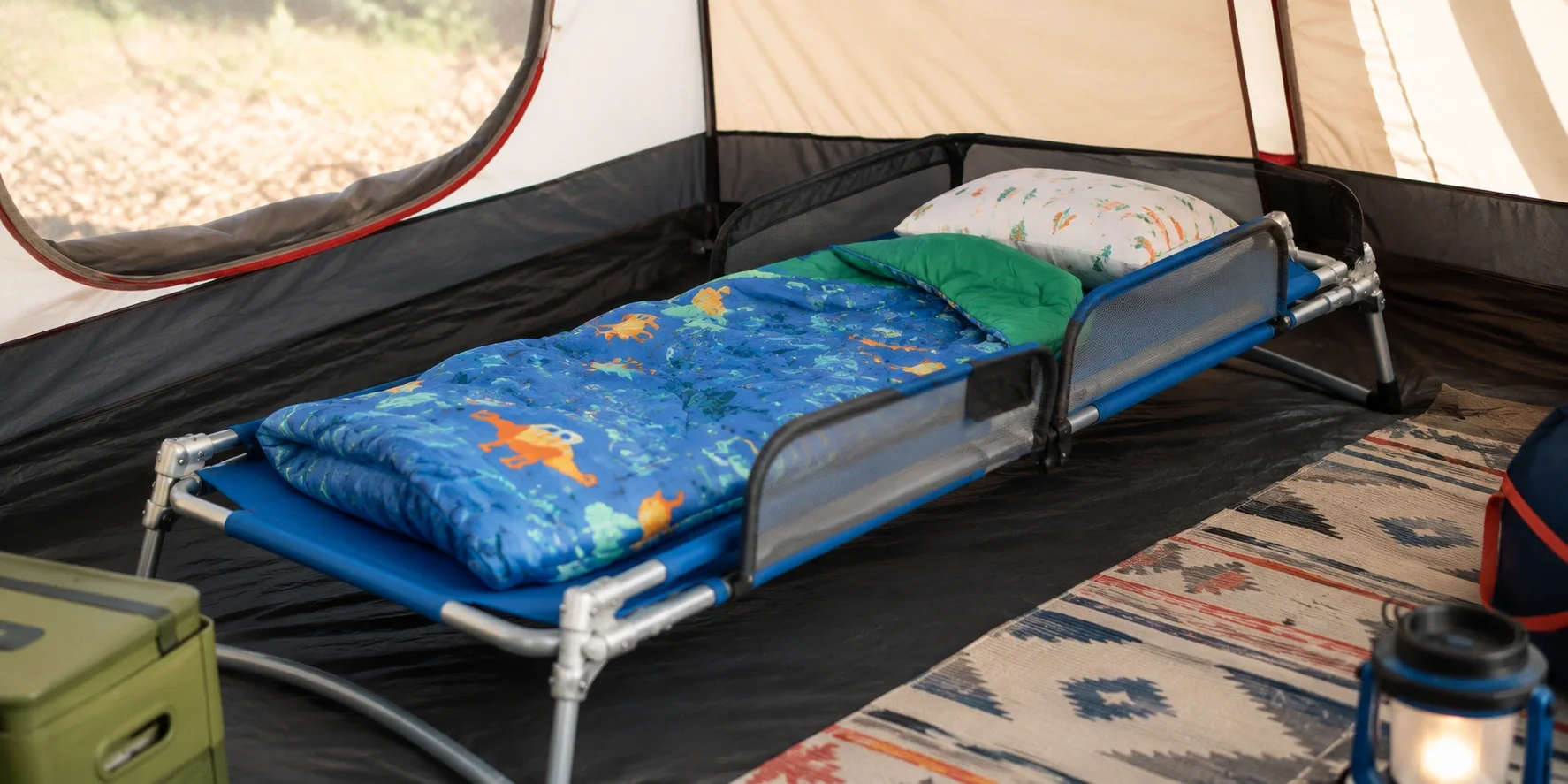 Small camping cot designed for children with safety rails
